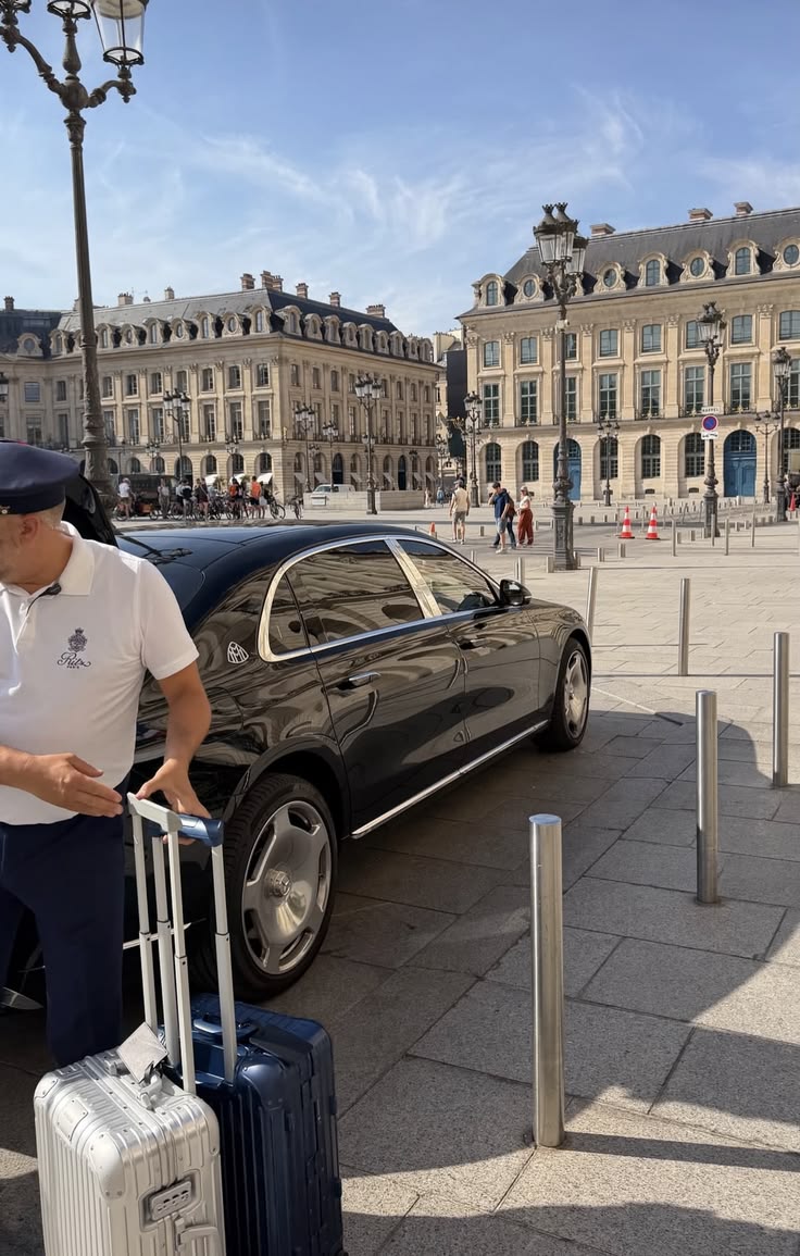 Mercedes-Maybach waiting on Place Vendôme, chauffeur and luggage ready beside the palace facades