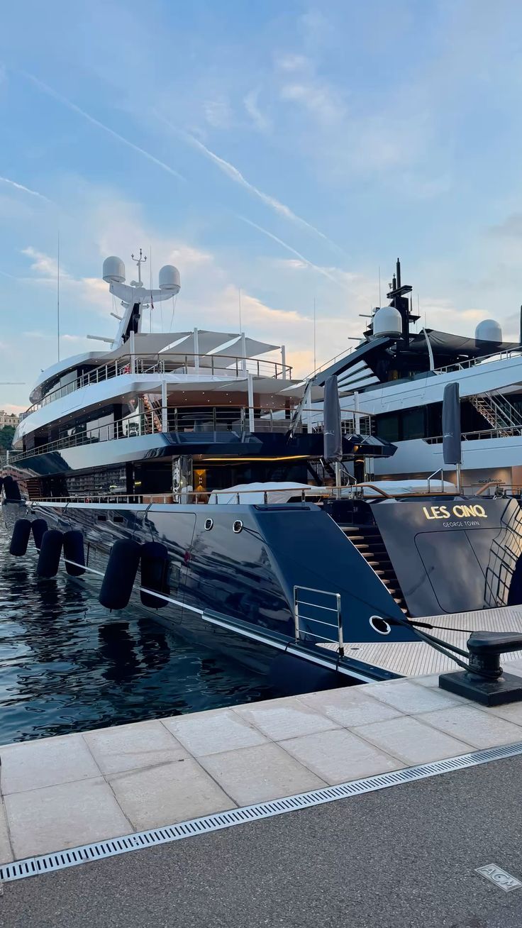 Superyachts moored side by side in Port Hercule Monaco at golden hour