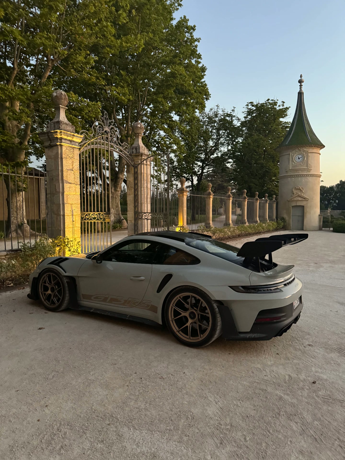 Porsche 911 GT3 RS at the gates of a private estate near Monaco at dusk